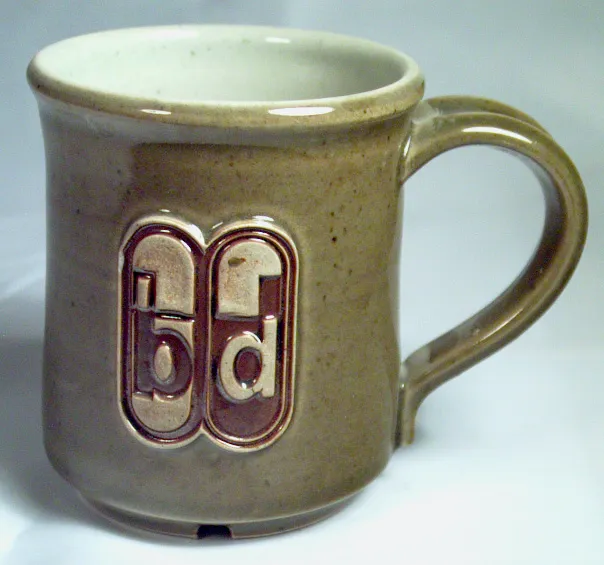 A mug with an embosses logo make by a letterpress stamp