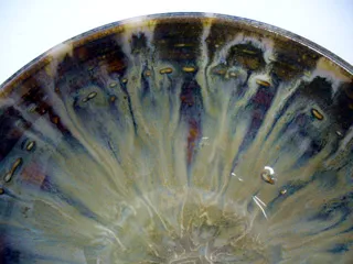 A fluid reduction rutile glaze is crawling