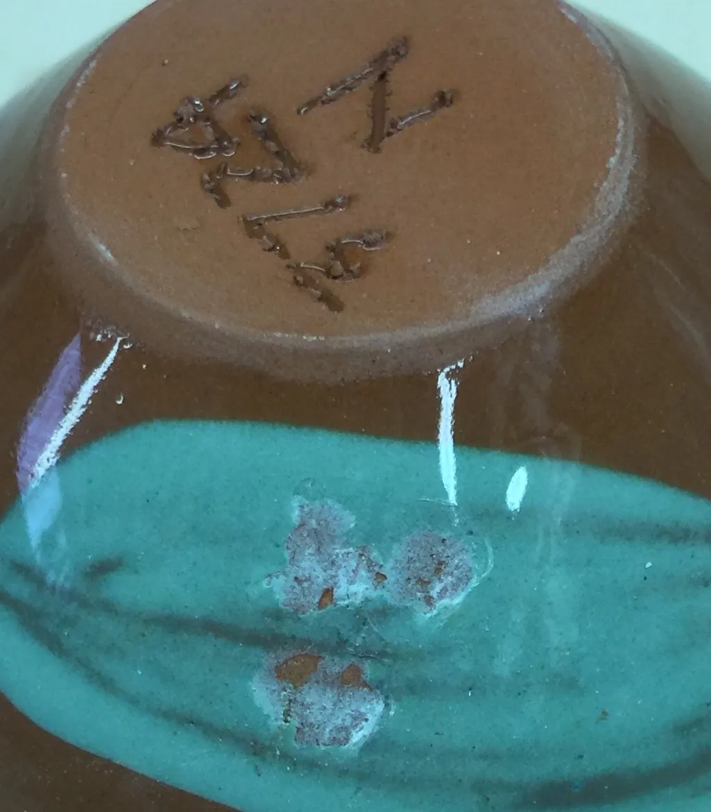 The green underglaze is failing on impact