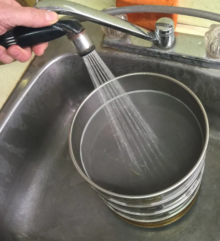 Washing clay through testing sieves