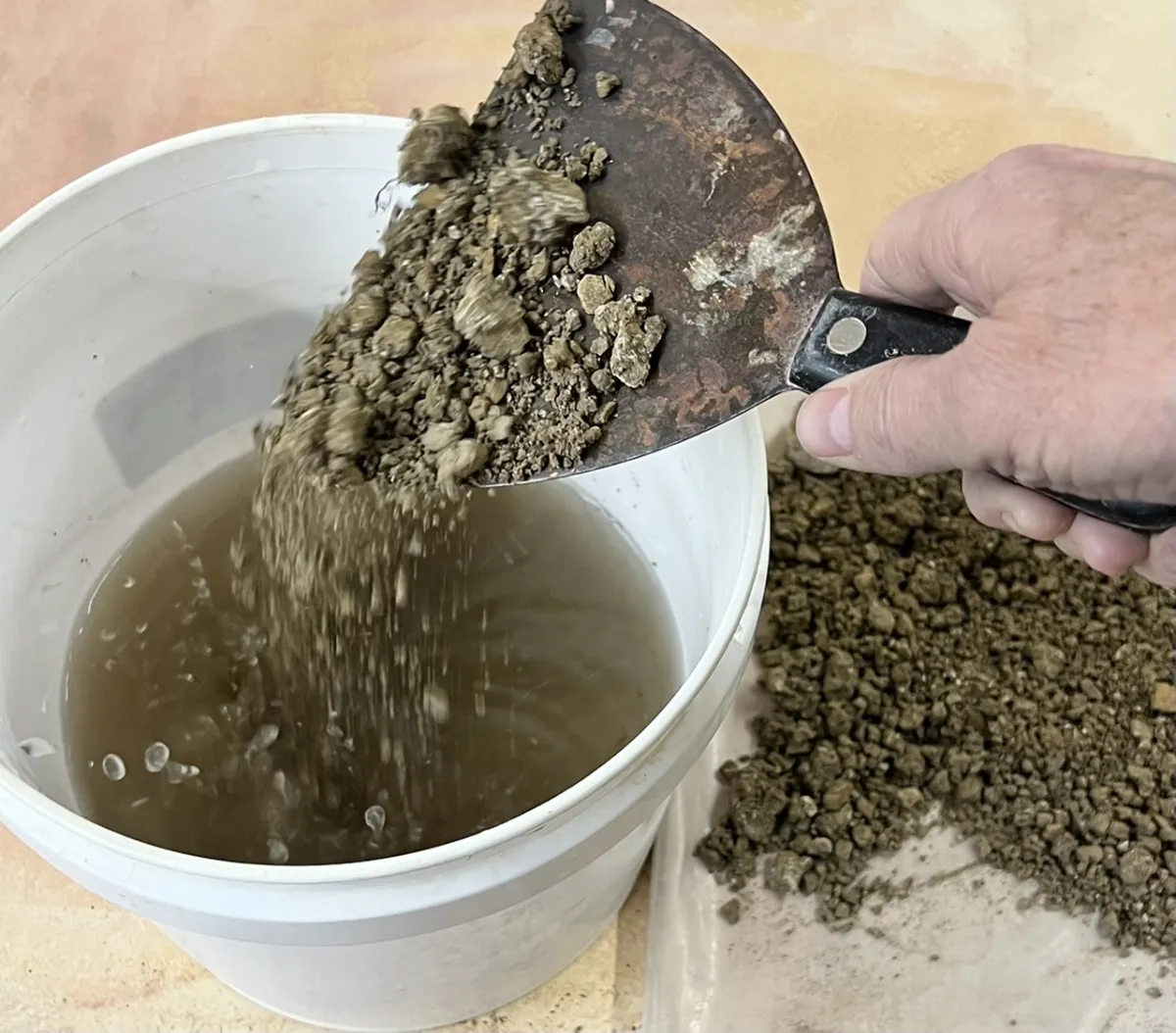 Pouring clay lumps into hot water