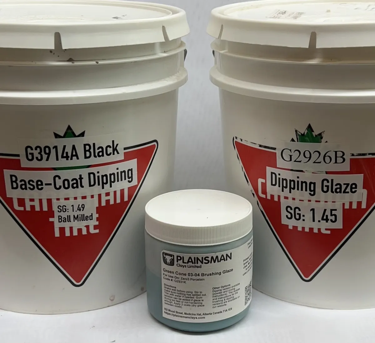 Three containers of glaze slurry