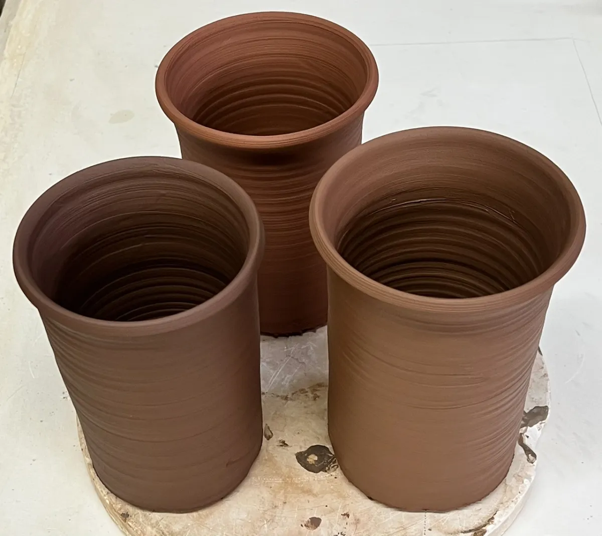 Three mugs are soft red clay