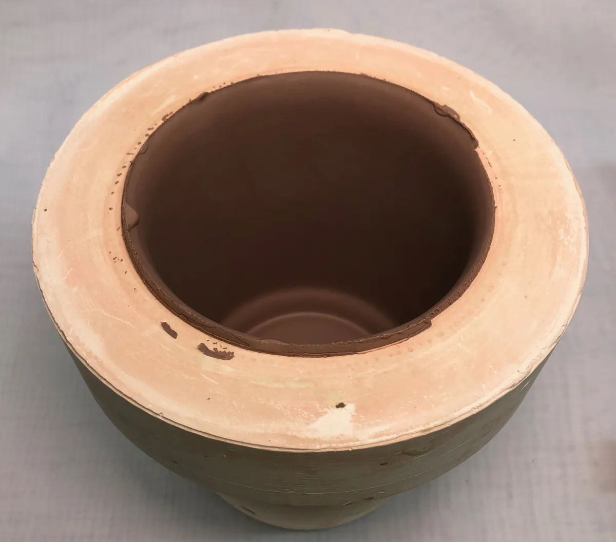 A plastic mold with a freshly cast mug about to be extracted