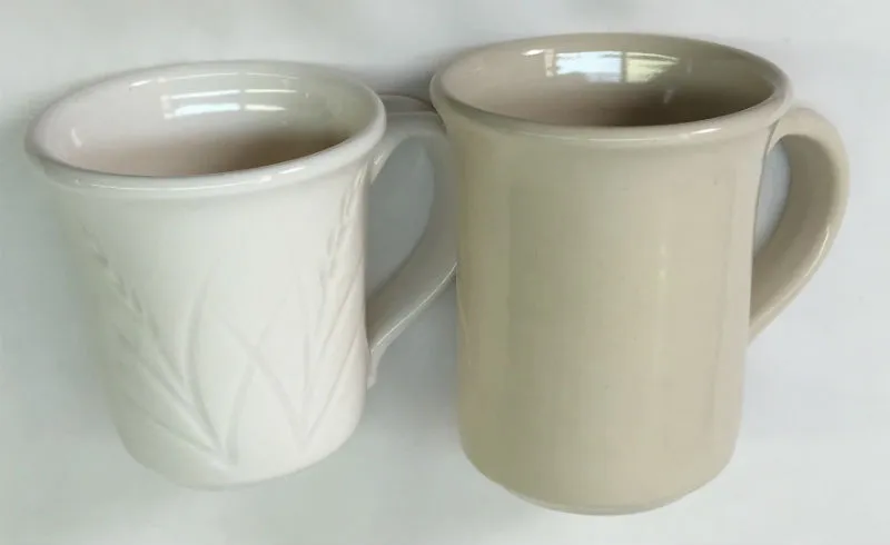 Side by side mugs, a porcelain made using only kaolin and one made with ball clay