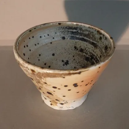Heavily speckled reduction fired porcelain Shino bowl by Glenn Lewis