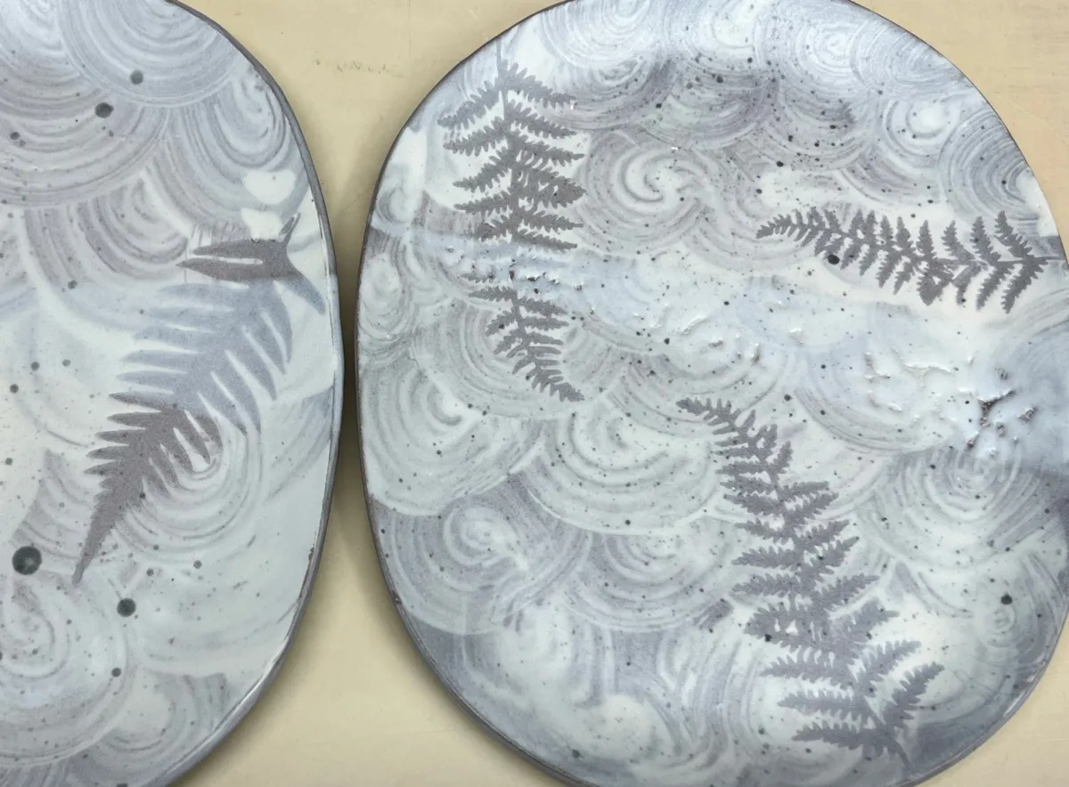Two slip decorated stoneware plates by Kat Valenzuela