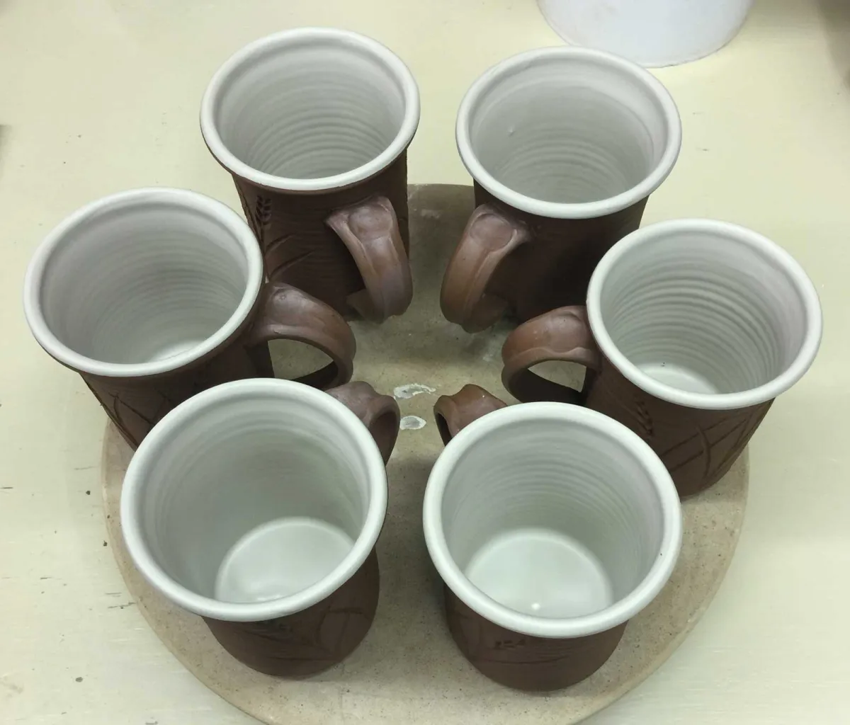 Leather hard mugs with waxed handles