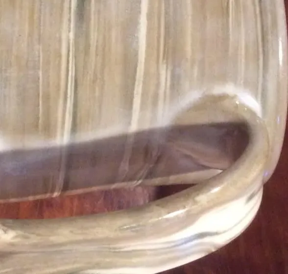 Clouding in a cone 7 clear glaze after ware in use