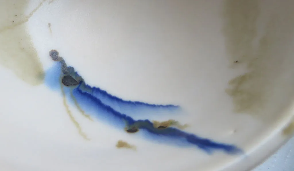 Cobalt and iron overglazes bleeding into the matte glaze
