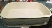 A casserole dish with a dunting crack going down from the rim