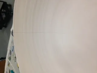 A large pottery bowl with a hairline crack down from the rim