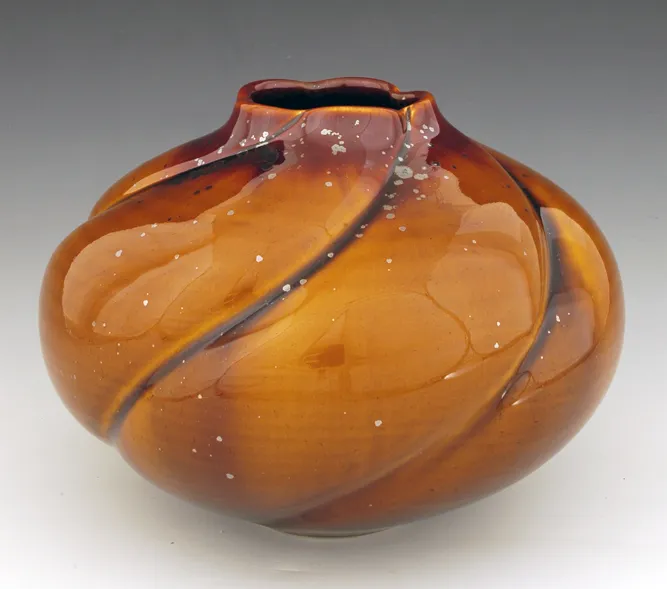 Scattered crystals on a highly melt fluid zinc free glaze