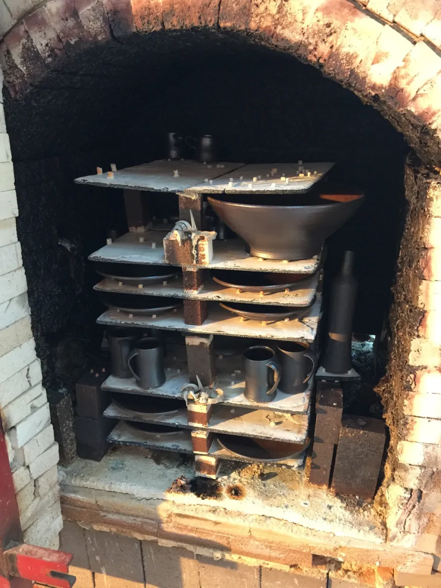 A studio salt kiln being unloaded