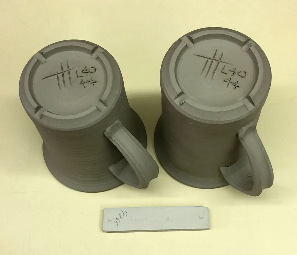 Two code-number ceramic mugs