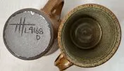 Two warping pottery mugs